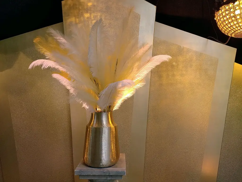 Golden vase with feathers