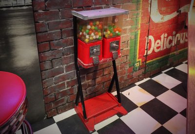 Two gumball Candy Dispensers on a standard